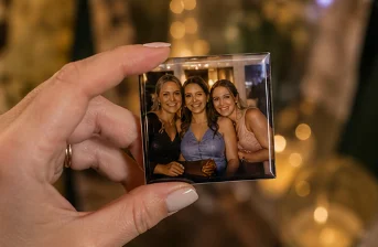 Wedding guest holding a custom photo magnet made live at the event
